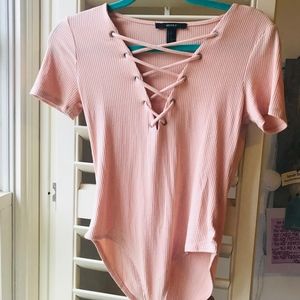 light pink laced up short sleeved body suit